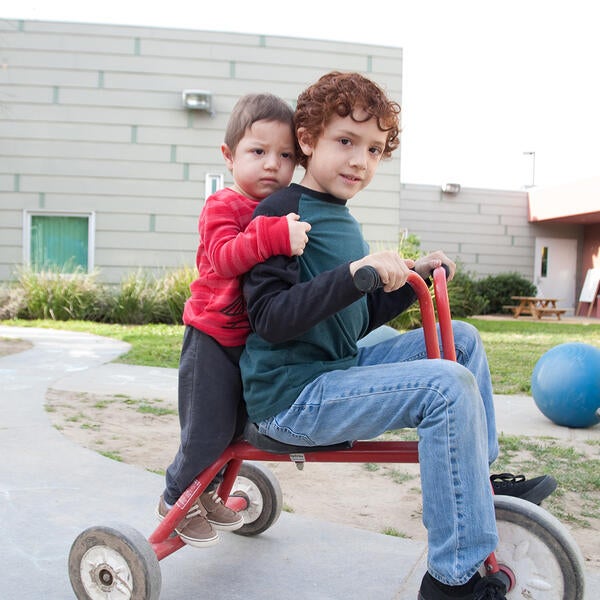 Kids on a tricycle